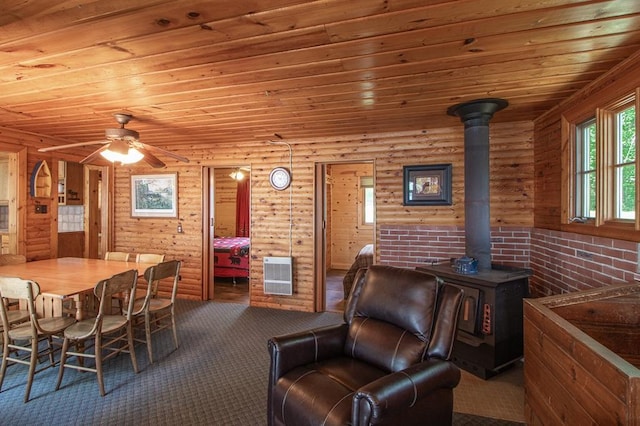 1378 Sunflower Trl NE, Outing, MN 56662 - carpeted dining area featuring wooden ceiling, heating unit, ceiling fan, a wood stove, and log walls