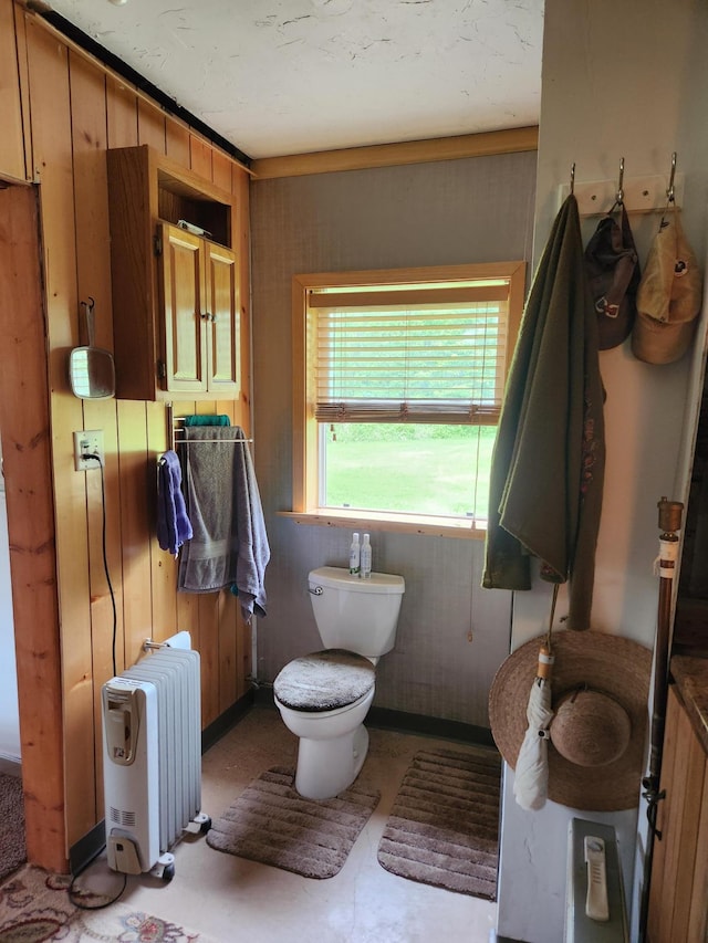 35270 Bear Creek Rd, Partridge Twp, MN 55704 - bathroom featuring radiator heating unit, toilet, and wood walls