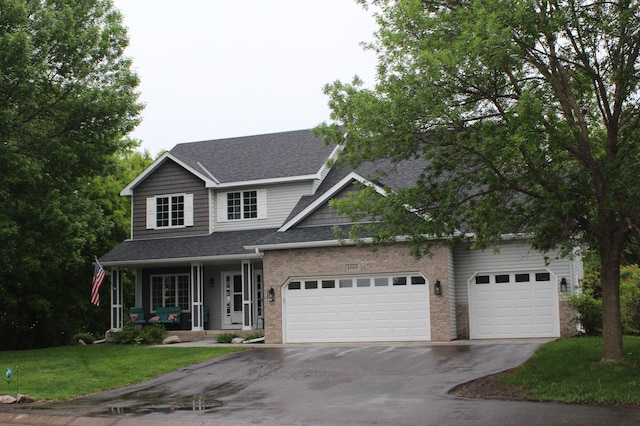 4860 Mason Ave NE, Saint Michael, MN 55376 - traditional home with asphalt driveway, a shingled roof, a garage, covered porch, and a front lawn