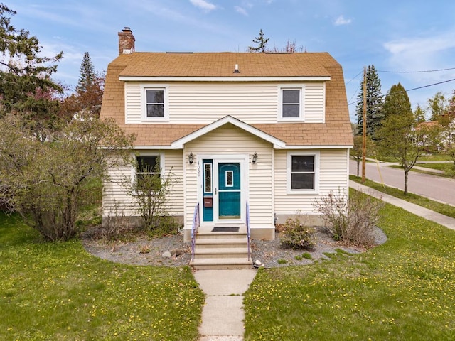 4031 Regent St, Duluth, MN 55804 - colonial inspired home featuring a chimney, a front lawn, and roof with shingles