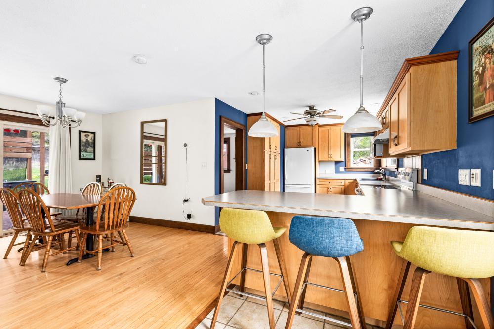 4031 Regent St, Duluth, MN 55804 - kitchen with freestanding refrigerator, healthy amount of natural light, a chandelier, and light countertops