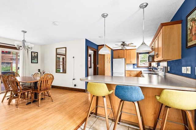 4031 Regent St, Duluth, MN 55804 - kitchen featuring freestanding refrigerator, plenty of natural light, baseboards, and a chandelier
