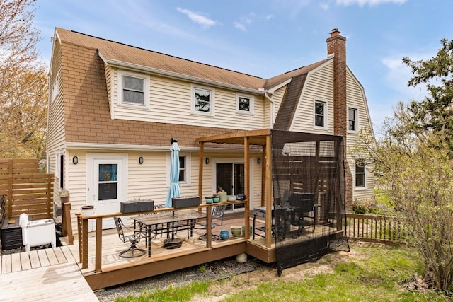 4031 Regent St, Duluth, MN 55804 - rear view of property with a gambrel roof, a deck, a chimney, outdoor dining space, and a shingled roof