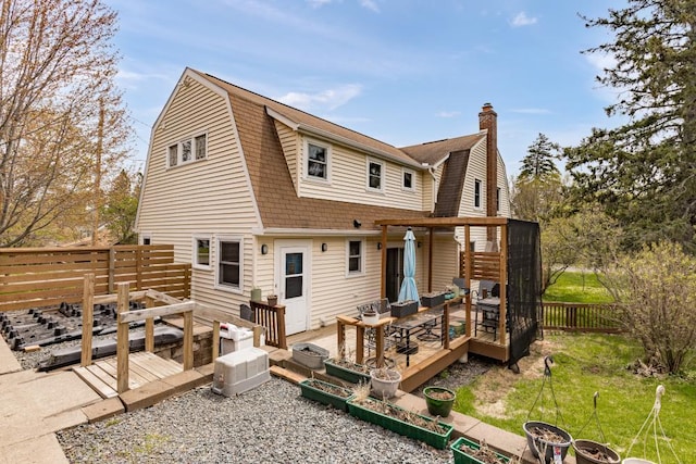 4031 Regent St, Duluth, MN 55804 - rear view of house with a gambrel roof, a deck, a chimney, and roof with shingles
