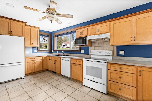4031 Regent St, Duluth, MN 55804 - kitchen with white appliances, under cabinet range hood, decorative backsplash, a ceiling fan, and light countertops