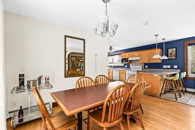 4031 Regent St, Duluth, MN 55804 - dining room with a chandelier, light wood-style floors, a baseboard radiator, and baseboards