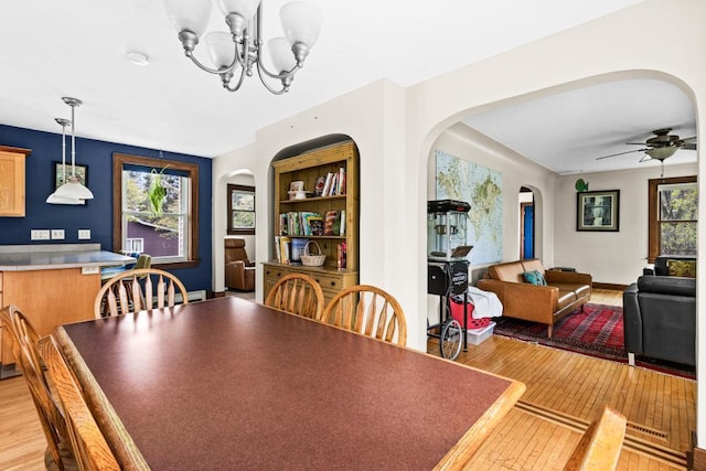 4031 Regent St, Duluth, MN 55804 - dining room featuring arched walkways, light wood-type flooring, a chandelier, and ceiling fan
