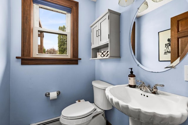 4031 Regent St, Duluth, MN 55804 - half bathroom with baseboard heating, toilet, and a sink