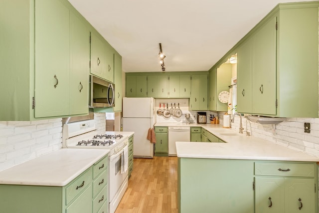 2816 29th Ave NE, Saint Anthony, MN 55418 - kitchen with white appliances, a sink, green cabinetry, and decorative backsplash