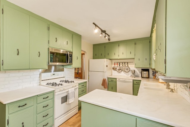 2816 29th Ave NE, Saint Anthony, MN 55418 - kitchen featuring white appliances, arched walkways, backsplash, light countertops, and a peninsula