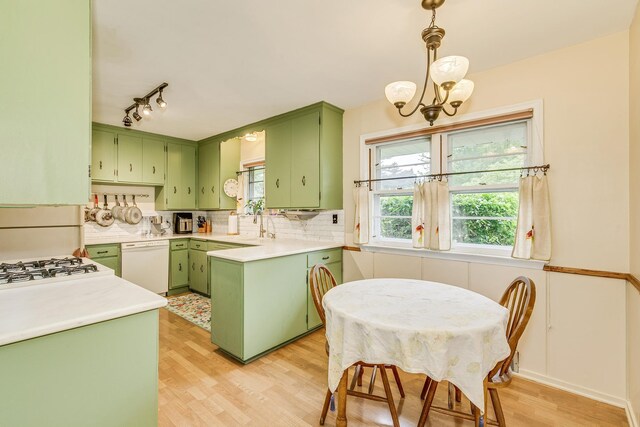 2816 29th Ave NE, Saint Anthony, MN 55418 - kitchen featuring green cabinetry, dishwasher, light wood-type flooring, and tasteful backsplash