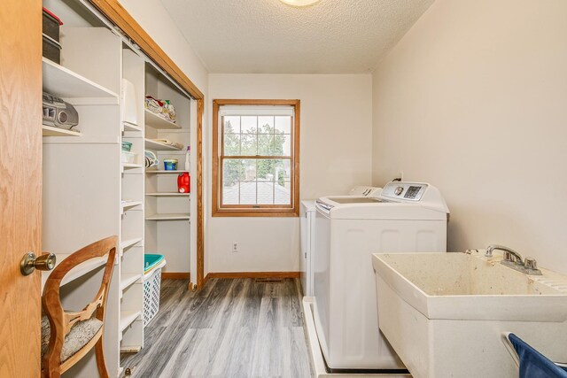 2816 29th Ave NE, Saint Anthony, MN 55418 - washroom with independent washer and dryer, wood finished floors, a textured ceiling, and baseboards