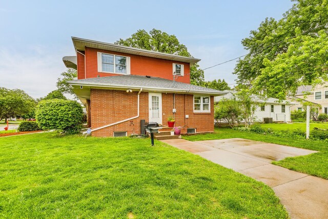 2816 29th Ave NE, Saint Anthony, MN 55418 - back of house with a yard, brick siding, and roof with shingles