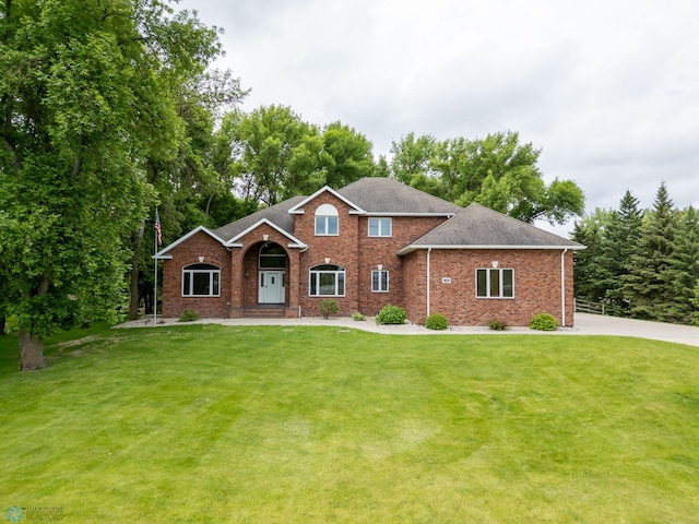 106 50th Ave E, Fargo, ND 58078 - view of front of property featuring a front lawn, brick siding, and a shingled roof