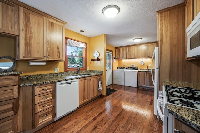 5404 Welcome Ave N, Crystal, MN 55429 - kitchen with washer and dryer, white appliances, a sink, a textured ceiling, and dark wood-style floors