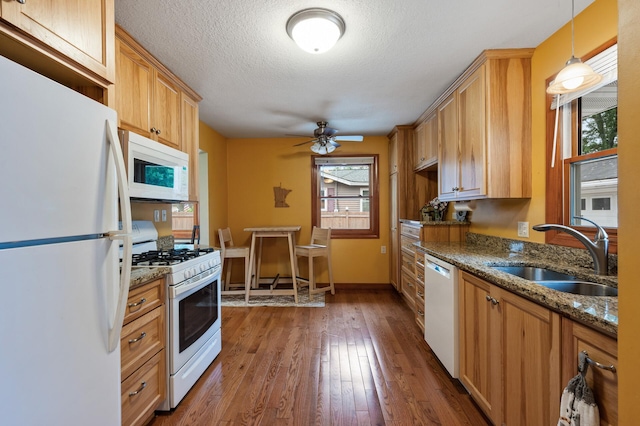 5404 Welcome Ave N, Crystal, MN 55429 - kitchen featuring white appliances, a sink, wood-type flooring, dark stone counters, and a textured ceiling