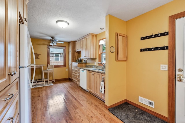 5404 Welcome Ave N, Crystal, MN 55429 - kitchen featuring white appliances, a sink, light brown cabinets, light wood finished floors, and ceiling fan