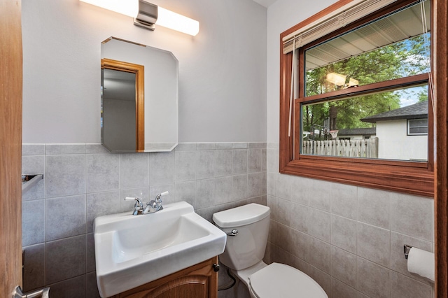 5404 Welcome Ave N, Crystal, MN 55429 - half bath with toilet, tile walls, vanity, and a wainscoted wall