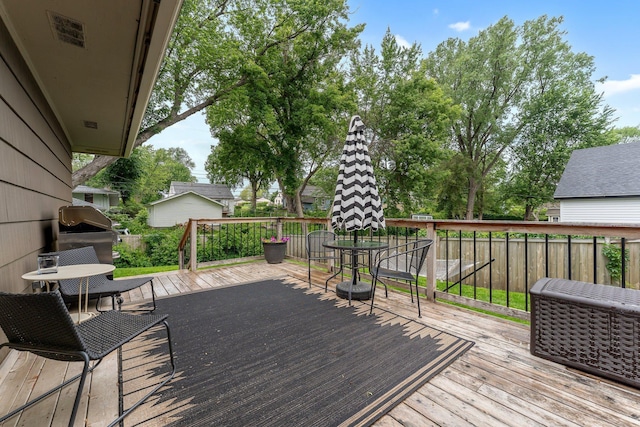 4600 3rd St NE, Fridley, MN 55421 - wooden deck with outdoor dining space and area for grilling