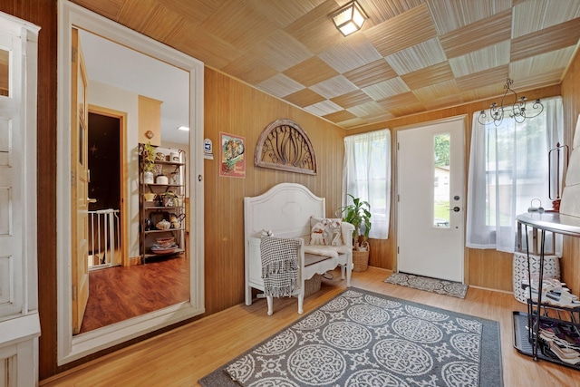 4600 3rd St NE, Fridley, MN 55421 - foyer with wood walls, a chandelier, and wood finished floors