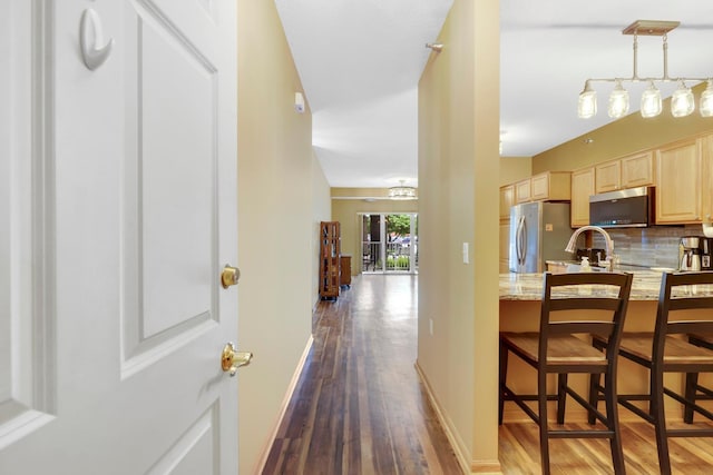 16154 Main Ave SE # 120, Prior Lake, MN 55372 - kitchen featuring light brown cabinets, stainless steel appliances, dark wood-type flooring, and tasteful backsplash