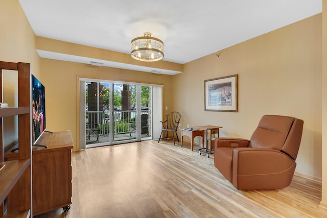 16154 Main Ave SE # 120, Prior Lake, MN 55372 - living area with light wood-style floors and a chandelier