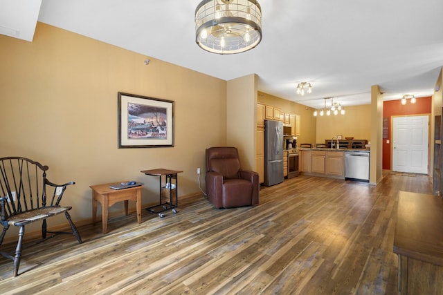 16154 Main Ave SE # 120, Prior Lake, MN 55372 - living area with a chandelier, wood finished floors, and baseboards