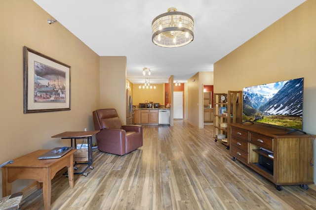 16154 Main Ave SE # 120, Prior Lake, MN 55372 - living room featuring a chandelier and light wood-style floors