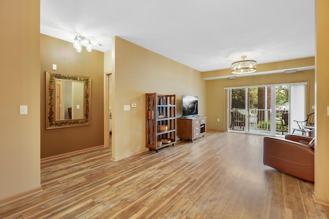 16154 Main Ave SE # 120, Prior Lake, MN 55372 - living room with a chandelier, wood finished floors, and baseboards