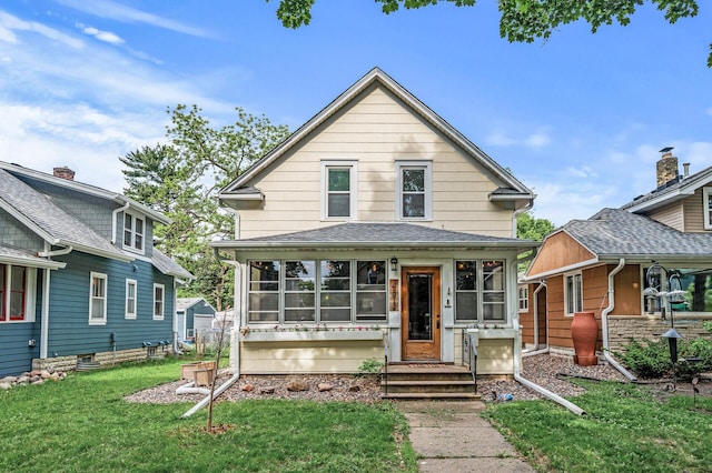 4312 Nokomis Ave, Minneapolis, MN 55406 - view of front of home featuring a sunroom, a front yard, entry steps, and a shingled roof