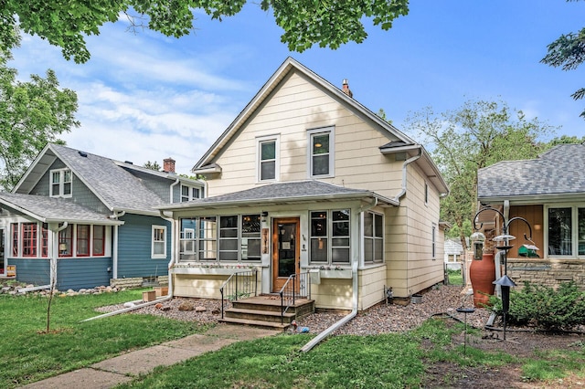 4312 Nokomis Ave, Minneapolis, MN 55406 - view of front facade with a sunroom and a front lawn