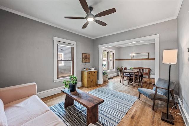 4312 Nokomis Ave, Minneapolis, MN 55406 - living room with light wood-style floors, a ceiling fan, baseboards, ornamental molding, and a chandelier