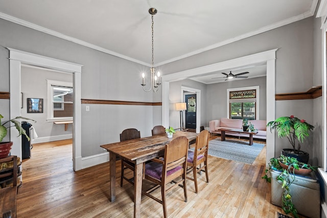 4312 Nokomis Ave, Minneapolis, MN 55406 - dining area with light wood-style floors, baseboards, ceiling fan, crown molding, and a chandelier