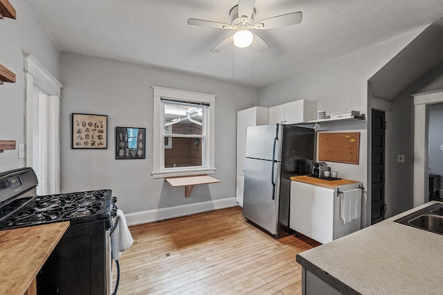 4312 Nokomis Ave, Minneapolis, MN 55406 - kitchen with gas range, freestanding refrigerator, light wood finished floors, ceiling fan, and baseboards
