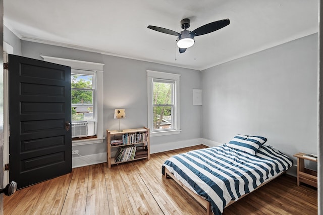 4312 Nokomis Ave, Minneapolis, MN 55406 - bedroom with multiple windows, hardwood / wood-style flooring, baseboards, ornamental molding, and ceiling fan