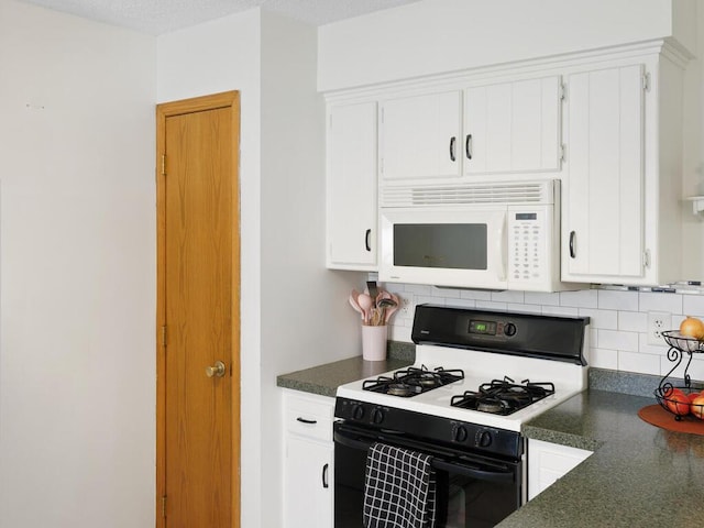 38609 Branch Ave, North Branch, MN 55056 - kitchen featuring white microwave, gas range oven, dark countertops, and backsplash