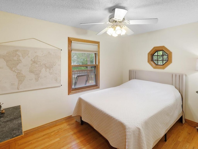 38609 Branch Ave, North Branch, MN 55056 - bedroom with light wood-style flooring, a textured ceiling, baseboards, and ceiling fan