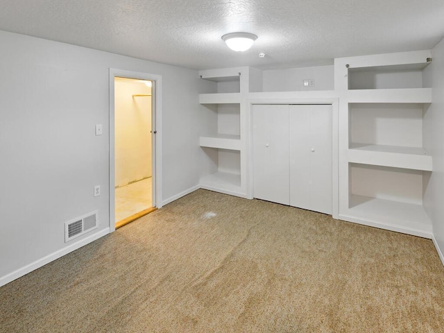 38609 Branch Ave, North Branch, MN 55056 - unfurnished bedroom featuring a textured ceiling, carpet floors, a closet, and baseboards