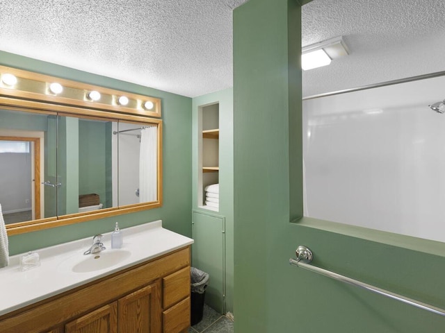 38609 Branch Ave, North Branch, MN 55056 - bathroom with a textured ceiling, vanity, toilet, and a shower