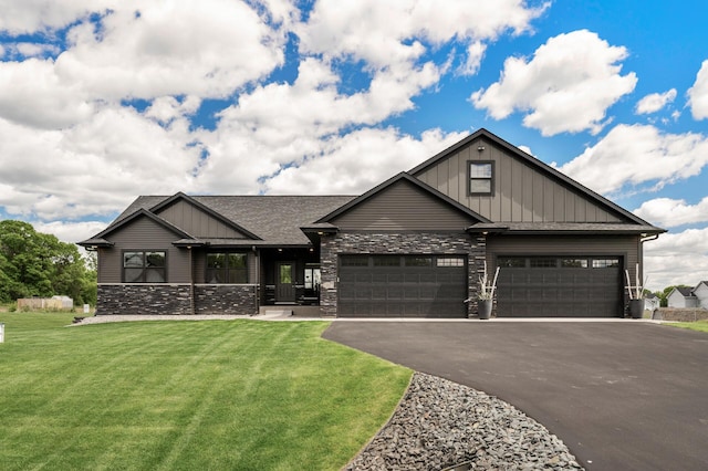 18885 Poppy St NW, Oak Grove, MN 55303 - craftsman house featuring board and batten siding, an attached garage, asphalt driveway, and a front lawn
