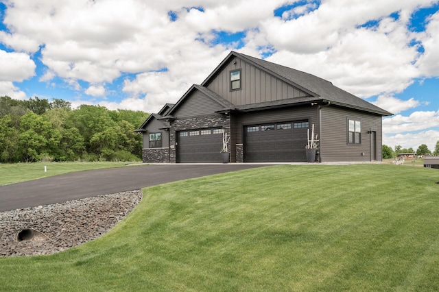 18885 Poppy St NW, Oak Grove, MN 55303 - view of property exterior with board and batten siding, an attached garage, asphalt driveway, and a yard