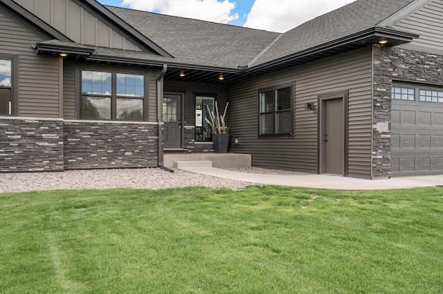 18885 Poppy St NW, Oak Grove, MN 55303 - rear view of property featuring stone siding, a lawn, and a shingled roof