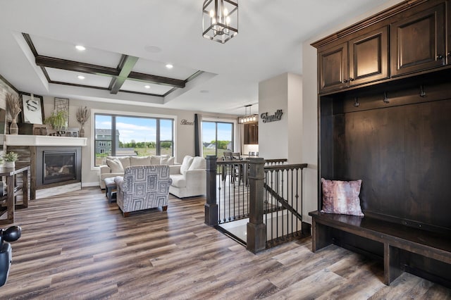 18885 Poppy St NW, Oak Grove, MN 55303 - living area featuring wood finished floors, coffered ceiling, a glass covered fireplace, recessed lighting, and a chandelier