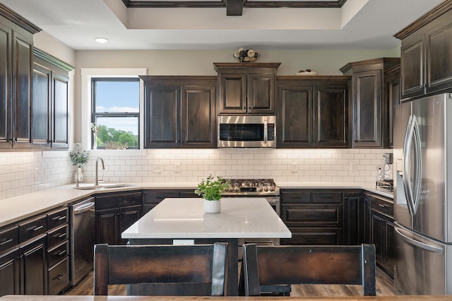 18885 Poppy St NW, Oak Grove, MN 55303 - kitchen featuring stainless steel appliances, a sink, backsplash, dark brown cabinets, and light stone counters