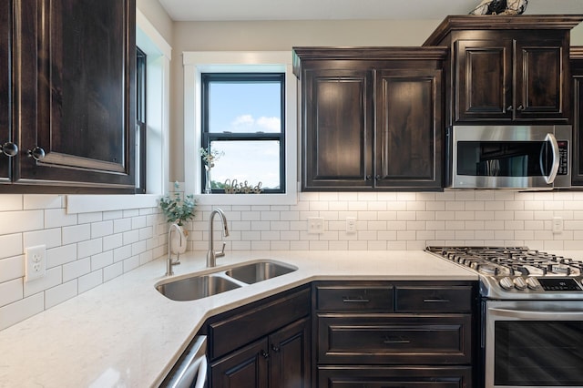 18885 Poppy St NW, Oak Grove, MN 55303 - kitchen with appliances with stainless steel finishes, a sink, tasteful backsplash, and dark brown cabinetry