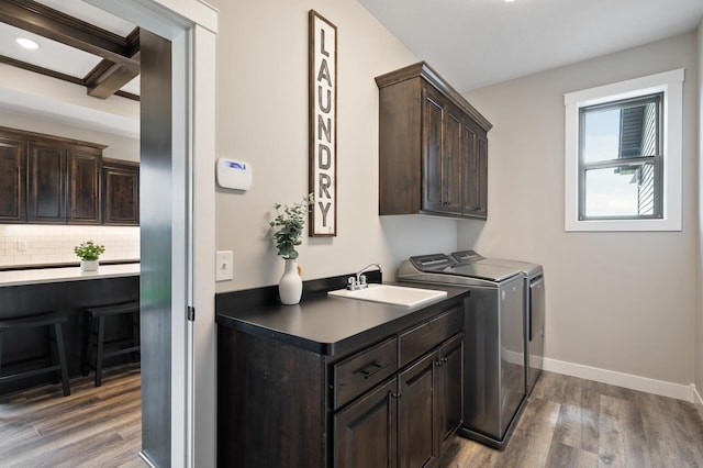 18885 Poppy St NW, Oak Grove, MN 55303 - laundry area with cabinet space, wood finished floors, separate washer and dryer, and baseboards