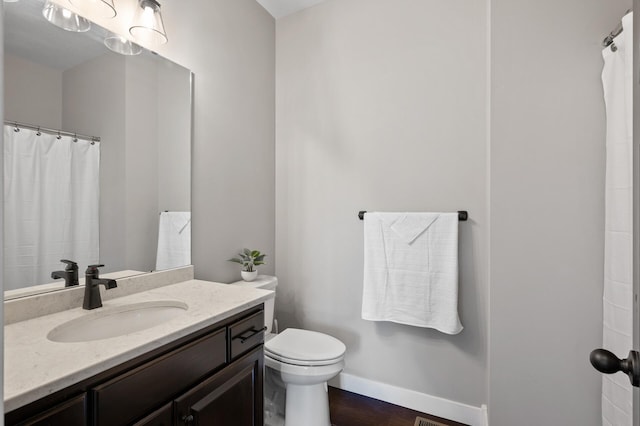18885 Poppy St NW, Oak Grove, MN 55303 - full bath featuring toilet, vanity, baseboards, and wood finished floors
