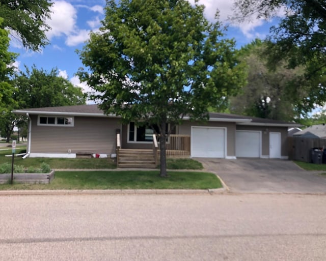 1304 13th Ave N, Moorhead, MN 56560 - view of front of home with asphalt driveway and an attached garage