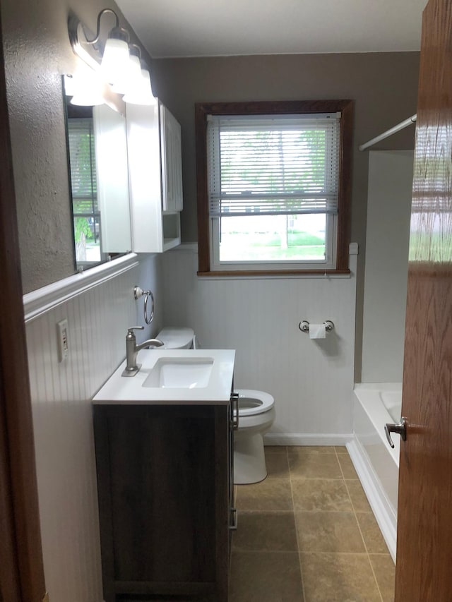1304 13th Ave N, Moorhead, MN 56560 - bathroom featuring toilet, vanity, and bathtub / shower combination