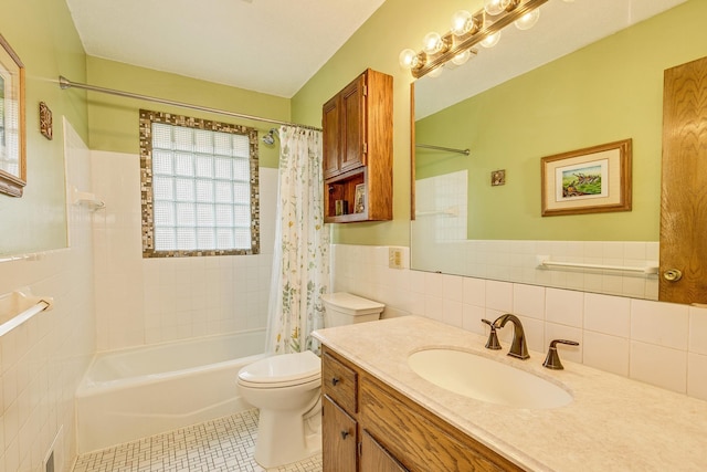 1357 64th Ave NE, Fridley, MN 55432 - full bathroom featuring tile walls, shower / tub combo, vanity, tile patterned flooring, and a wainscoted wall